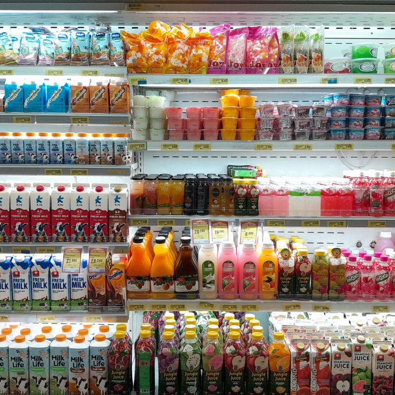 Convenience store shelves with drinks snacks and grocery products